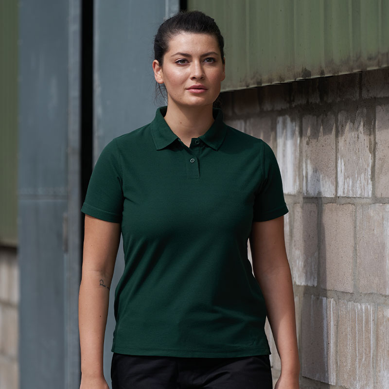 brunette woman wearing green polo shirt